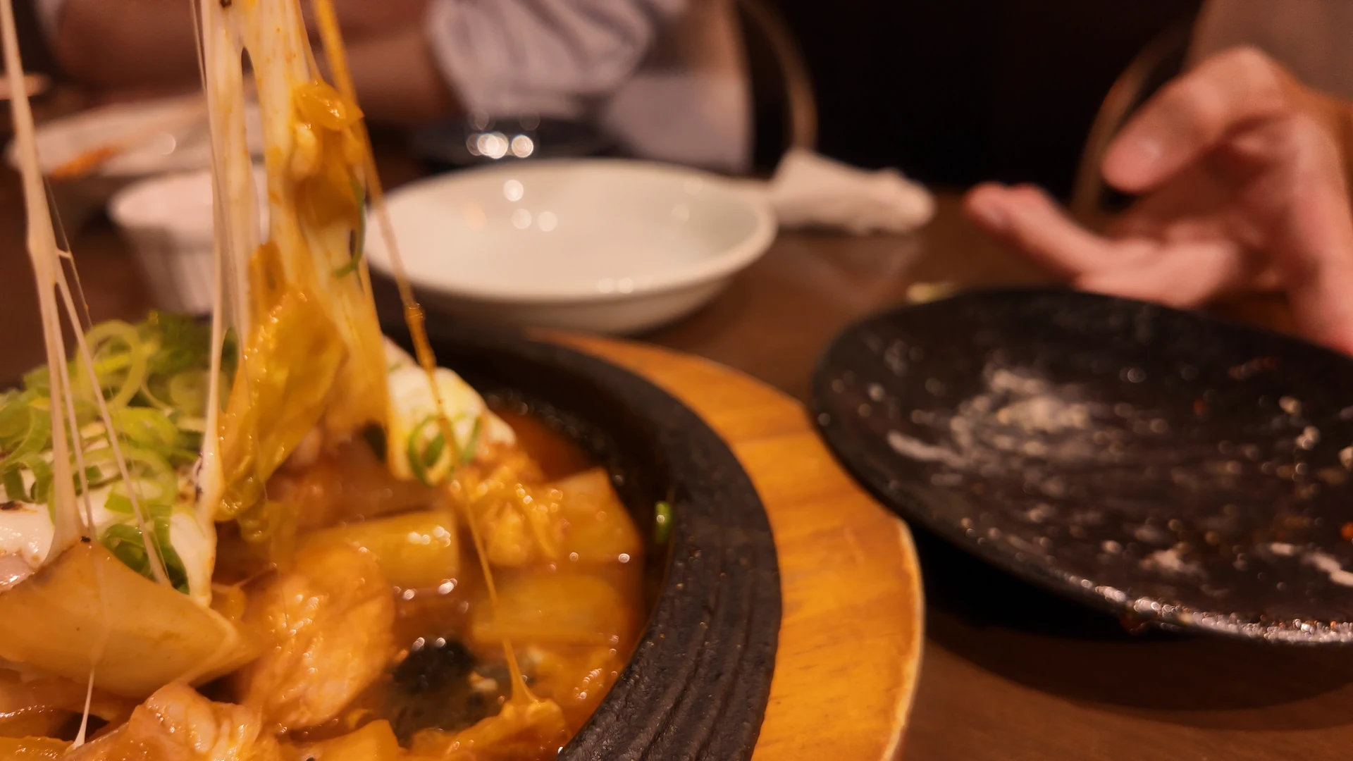 Melted cheese stretching from cheese dakgalbi at Chijimi Noda