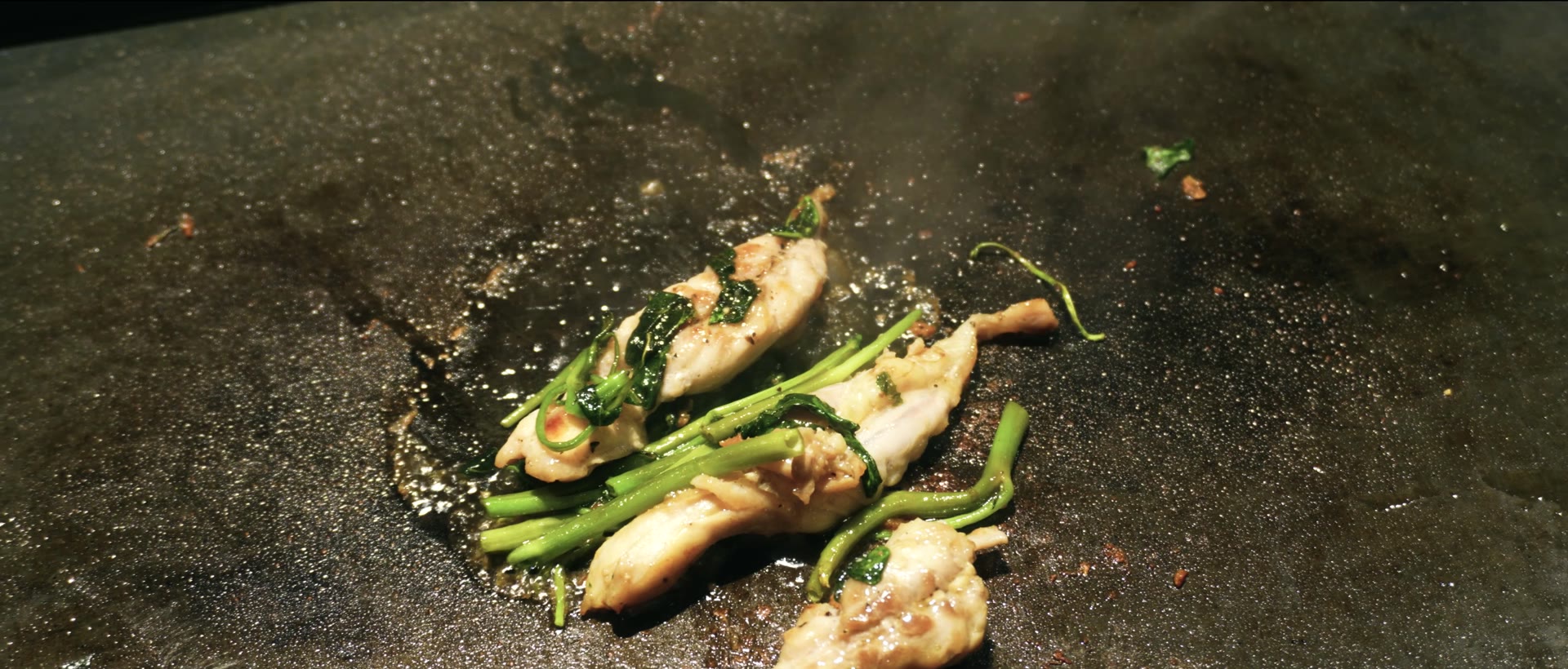 Chicken and water spinach with garlic-soy seasoning on the griddle