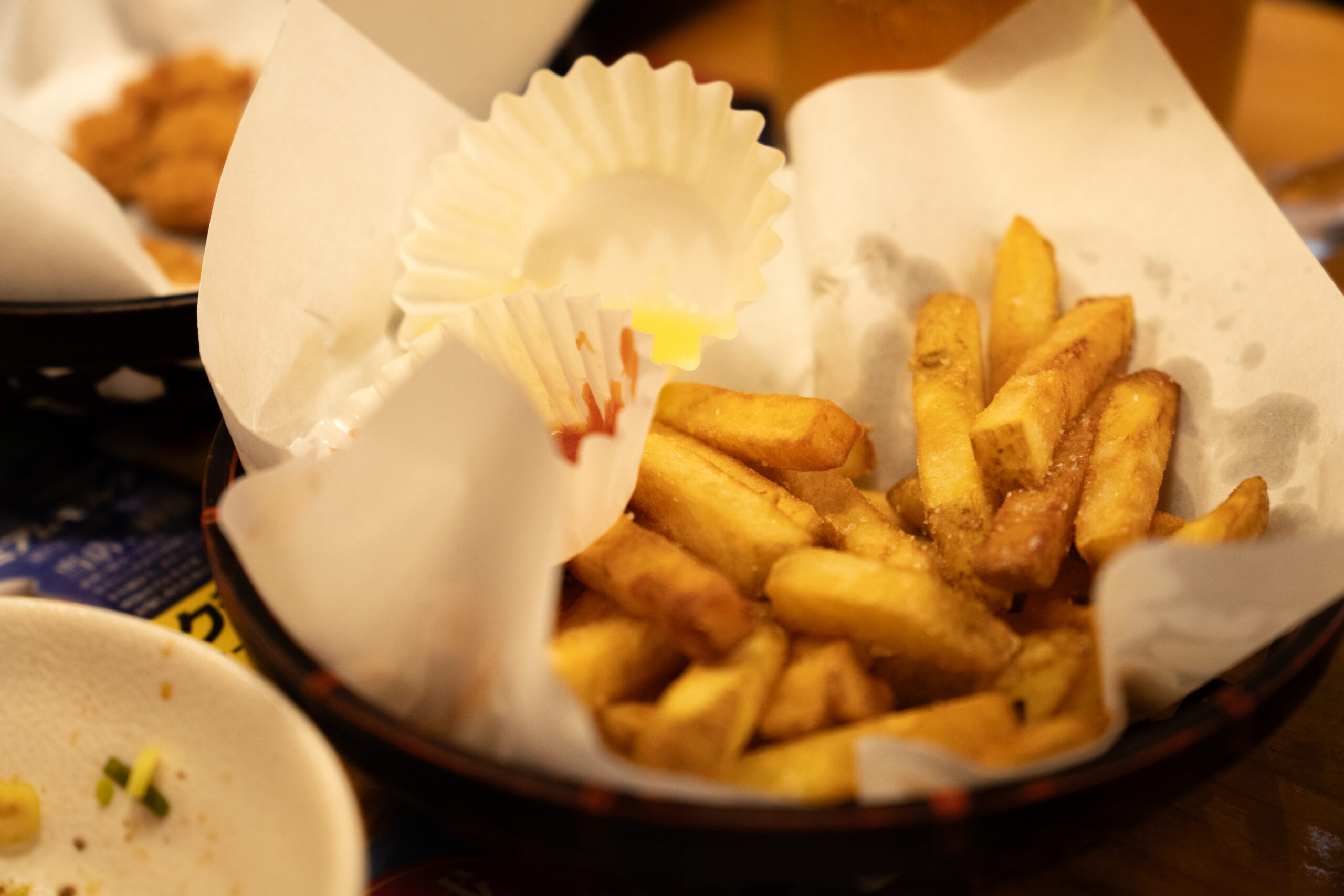 Thick-cut fries with butter sauce and ketchup at Torikizoku